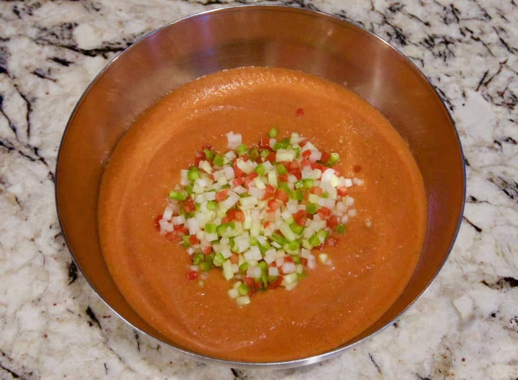 Chopped vegetables on top of gazpacho