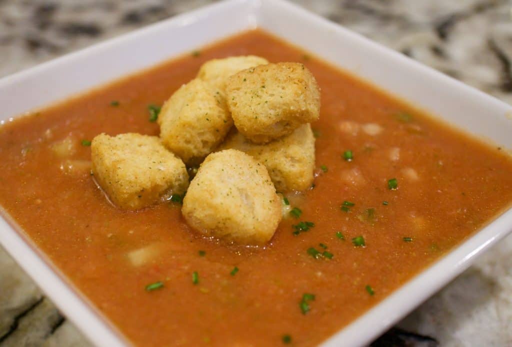 Super Healthy Classic Gazpacho in a white bowl with croutons