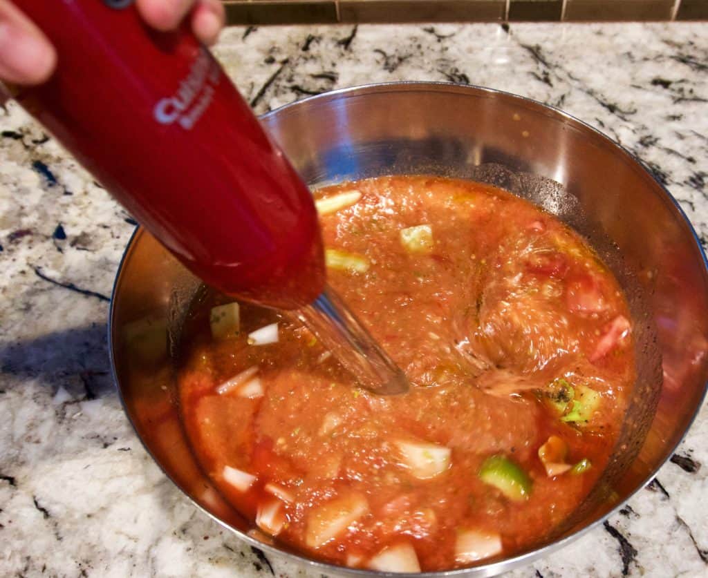 Using an immersion blender to incorporate ingredients for gazpacho