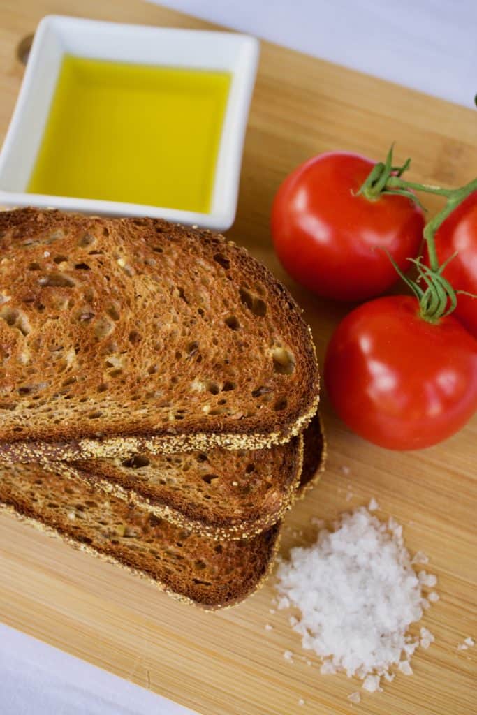 Four ingredients for pan con tomate: bread, vine-ripened tomatoes, good olive oil, and sea salt