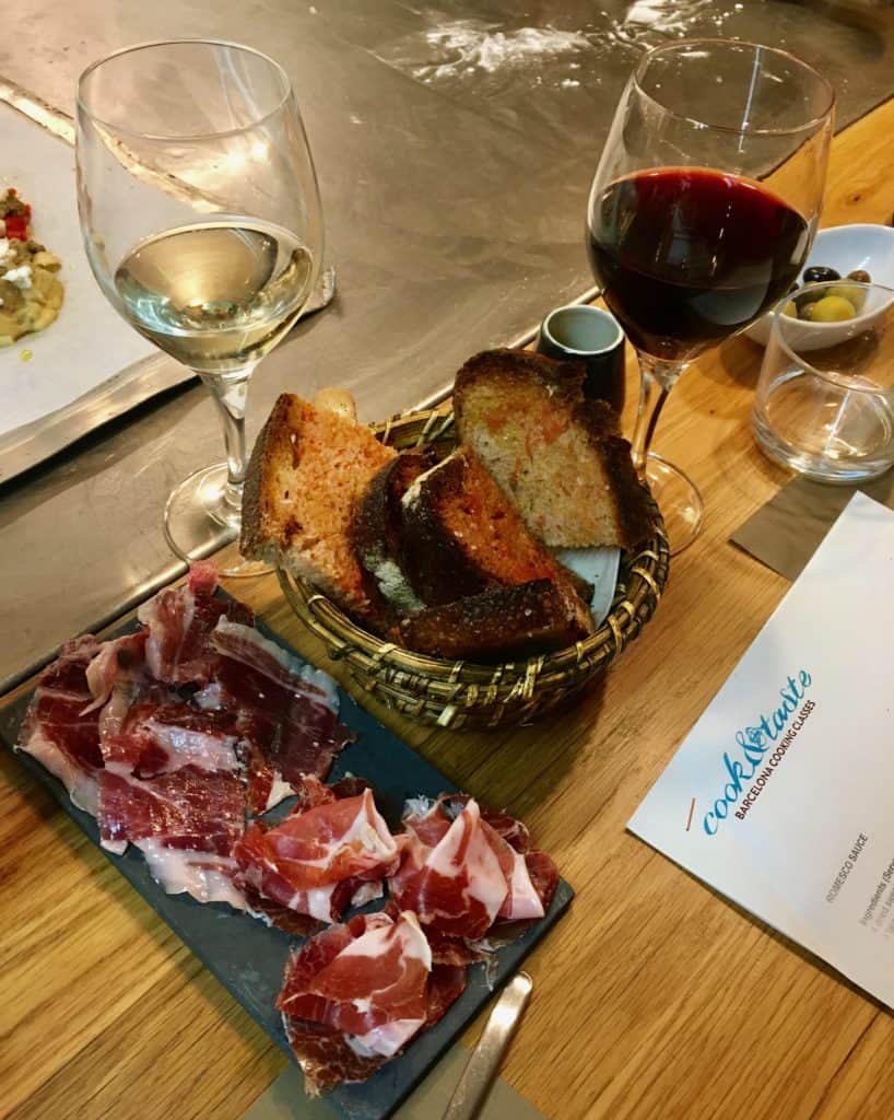 Bread, serrano and Iberian ham with two glasses of red and white wine
