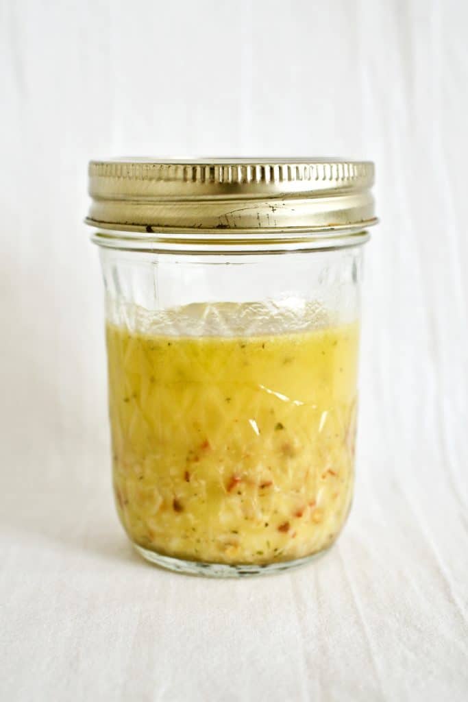 Lemon and garlic vinaigrette in a mason jar