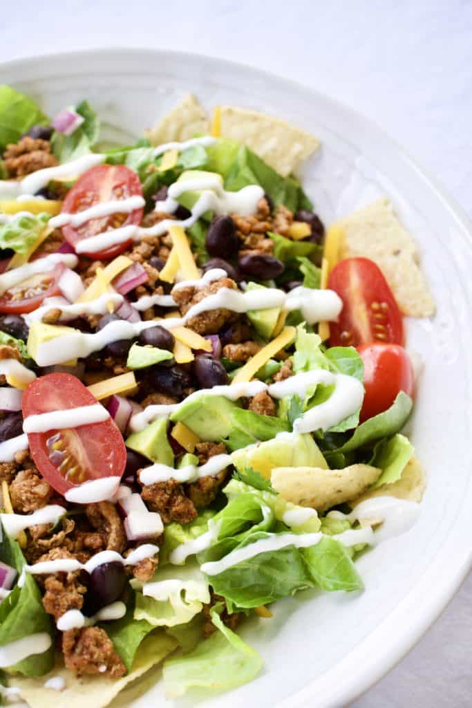 Closeup image of taco salad in a white bowl