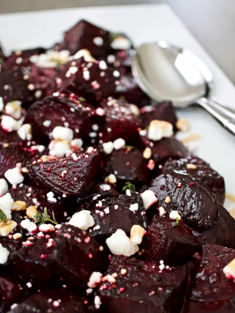 Roasted beets with goat cheese and balsamic reduction on a serving platter