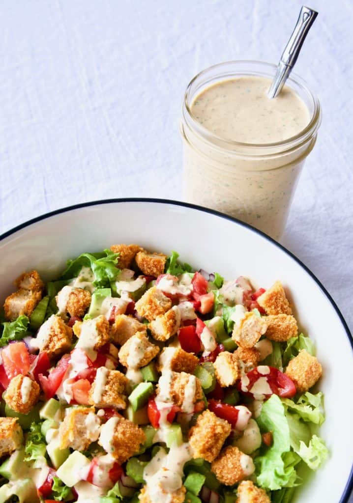 Magical chipotle ranch dressing drizzled onto a salad