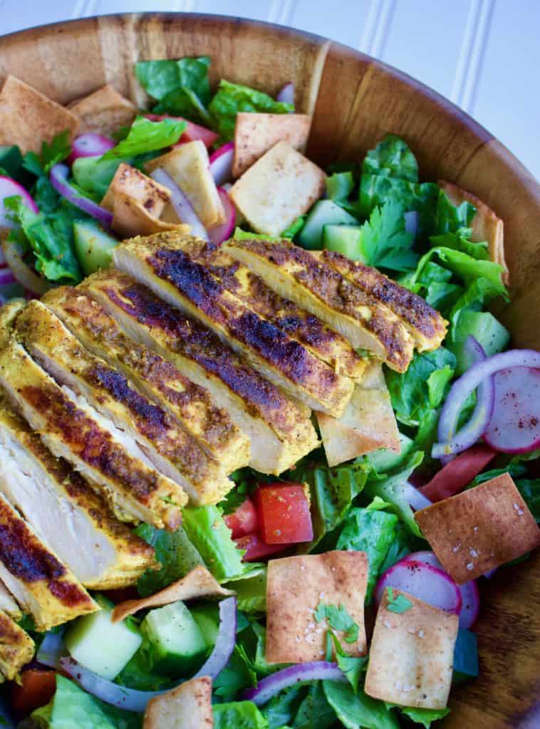 Closeup view of fattoush salad with shawarma-spiced chicken