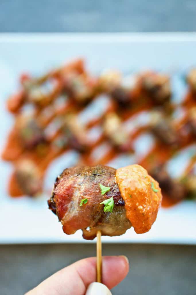 A bacon wrapped date on a toothpick