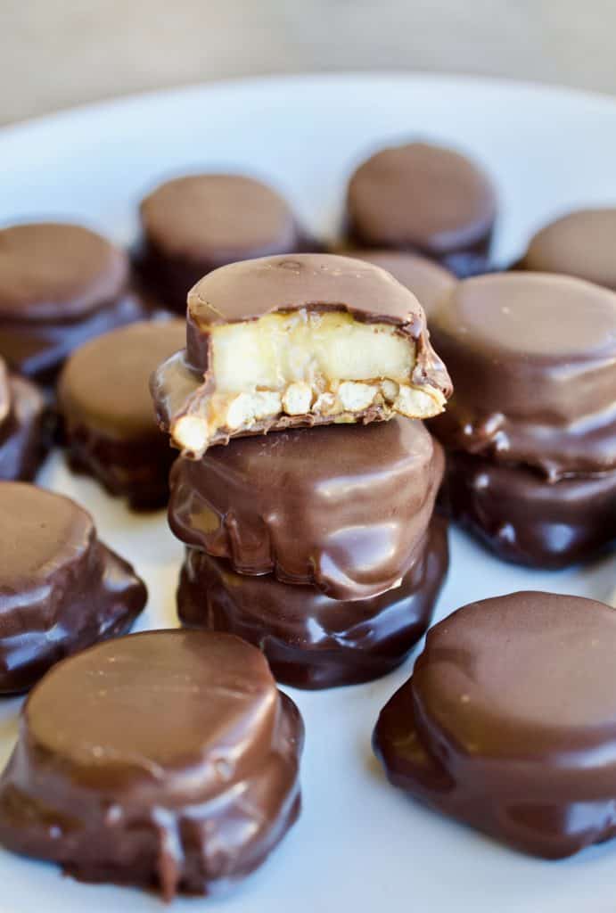 Stacked chocolate peanut butter banana bites with one having a bite taken out of it. 