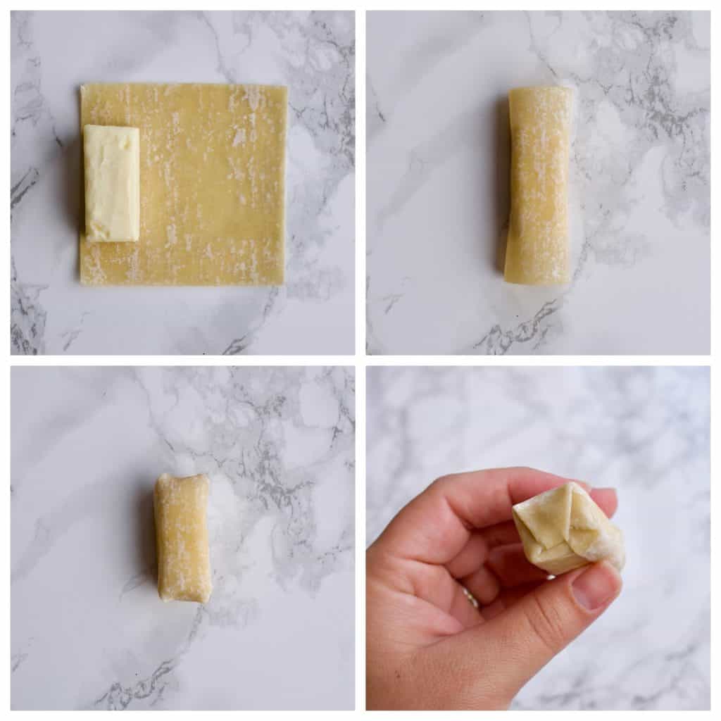 Rolling a piece of brie cheese into a wonton wrapper