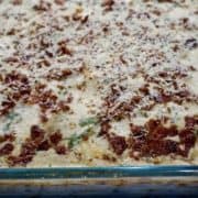 Boursin and bacon scalloped potatoes in a glass baking dish