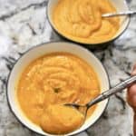Two bowls of butternut squash and sweet potato soup