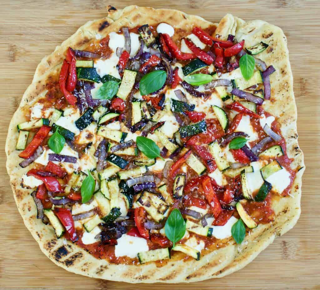 Overhead view of whole grilled veggie pizza