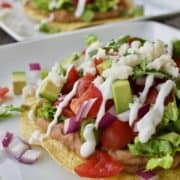 Insanely easy refried bean tostadas on a white plate