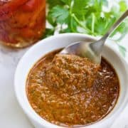 Dipping a spoonful of red pepper chermoula