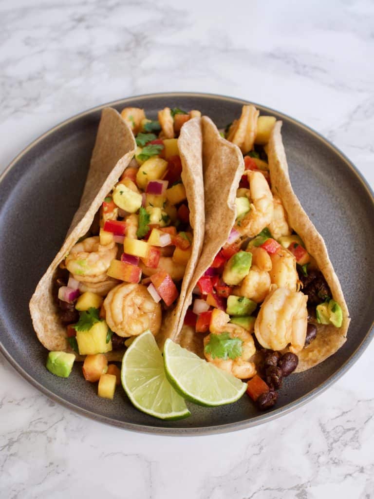 Chipotle Lime Shrimp Tacos on plate with limes