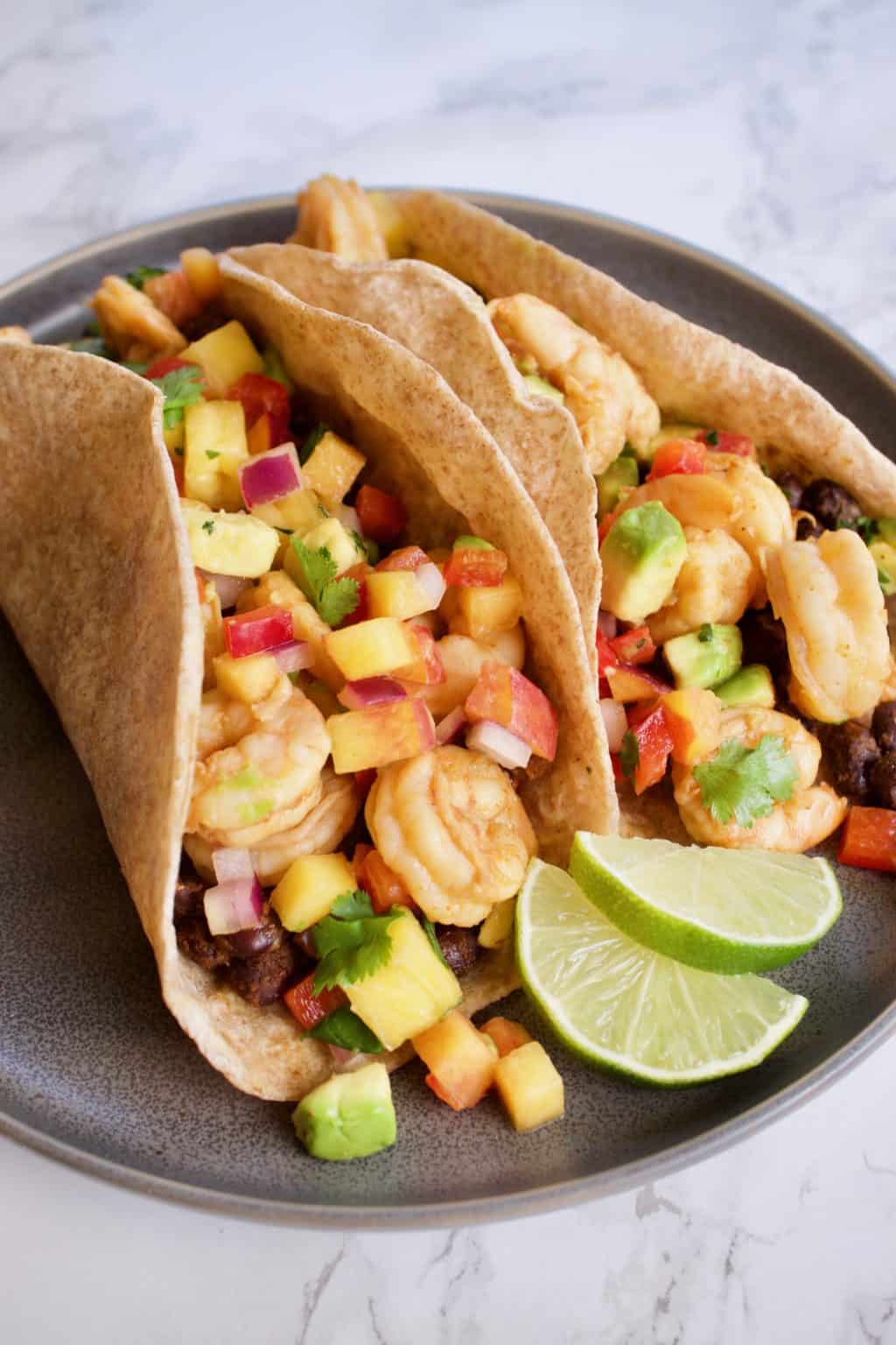 Chipotle Lime Shrimp Tacos with Pineapple Peach Salsa - Yummy Noises