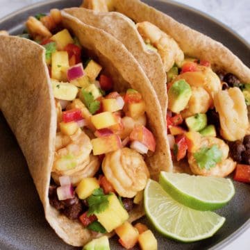 Chipotle Lime Shrimp Tacos on plate with limes