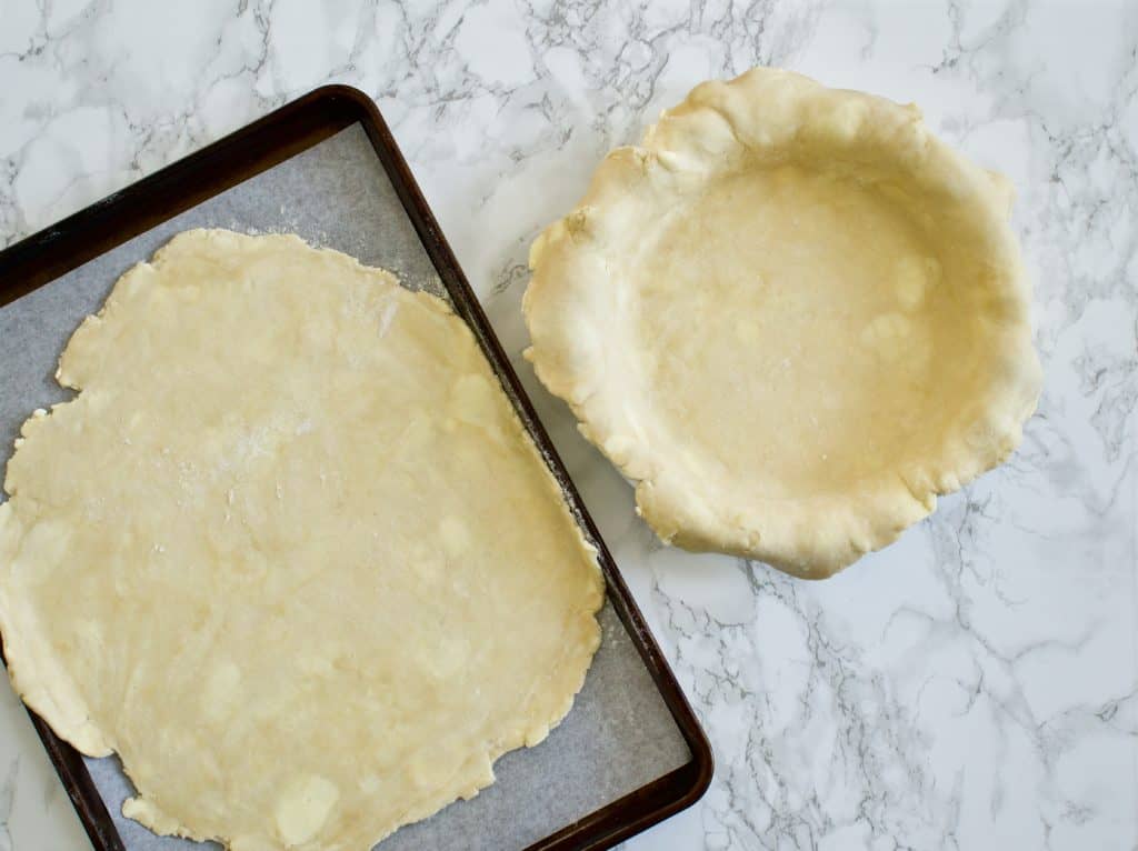pie crust rolled out onto sheet pan and pie crust rolled out and in pie plate