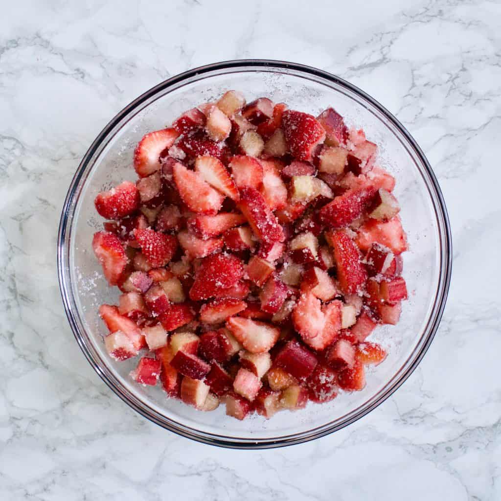 large bowl of strawberries and rhubarb mixed with sugar